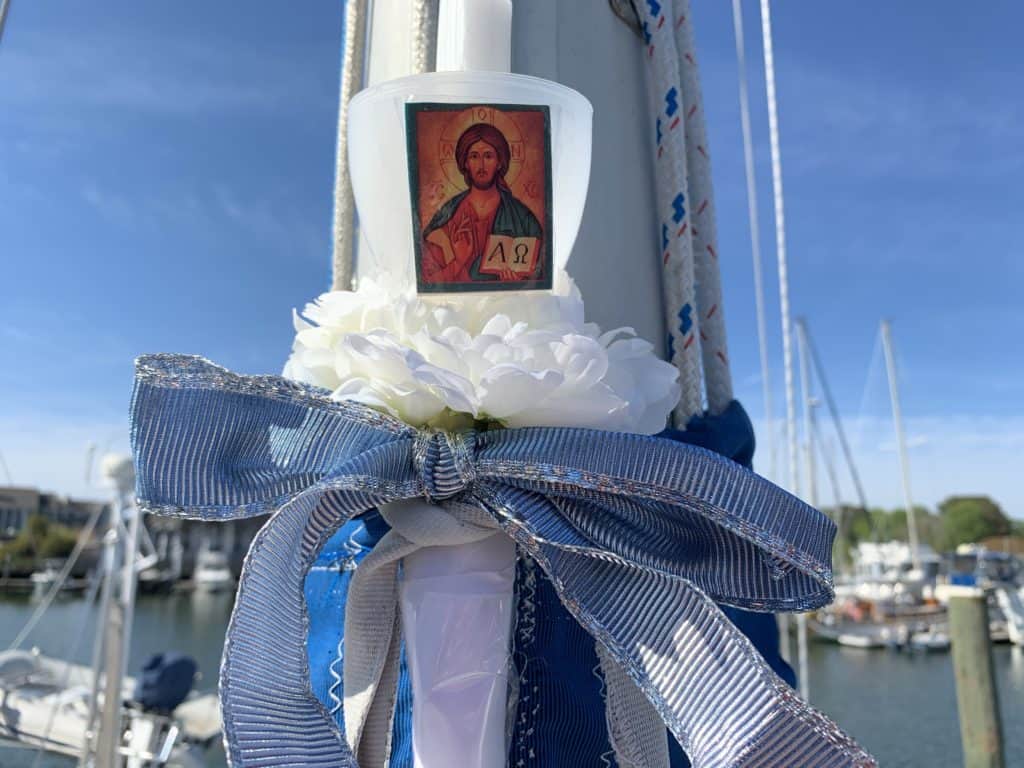 a candle with an icon, tied to a boat mast