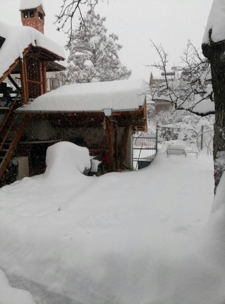 Snow covering the yard of a village house.