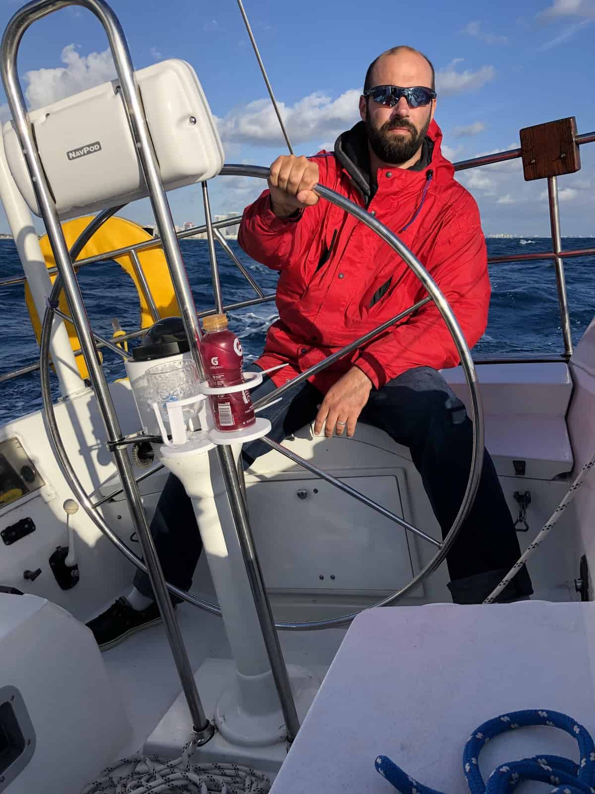 A man at the helm of a healed monohull