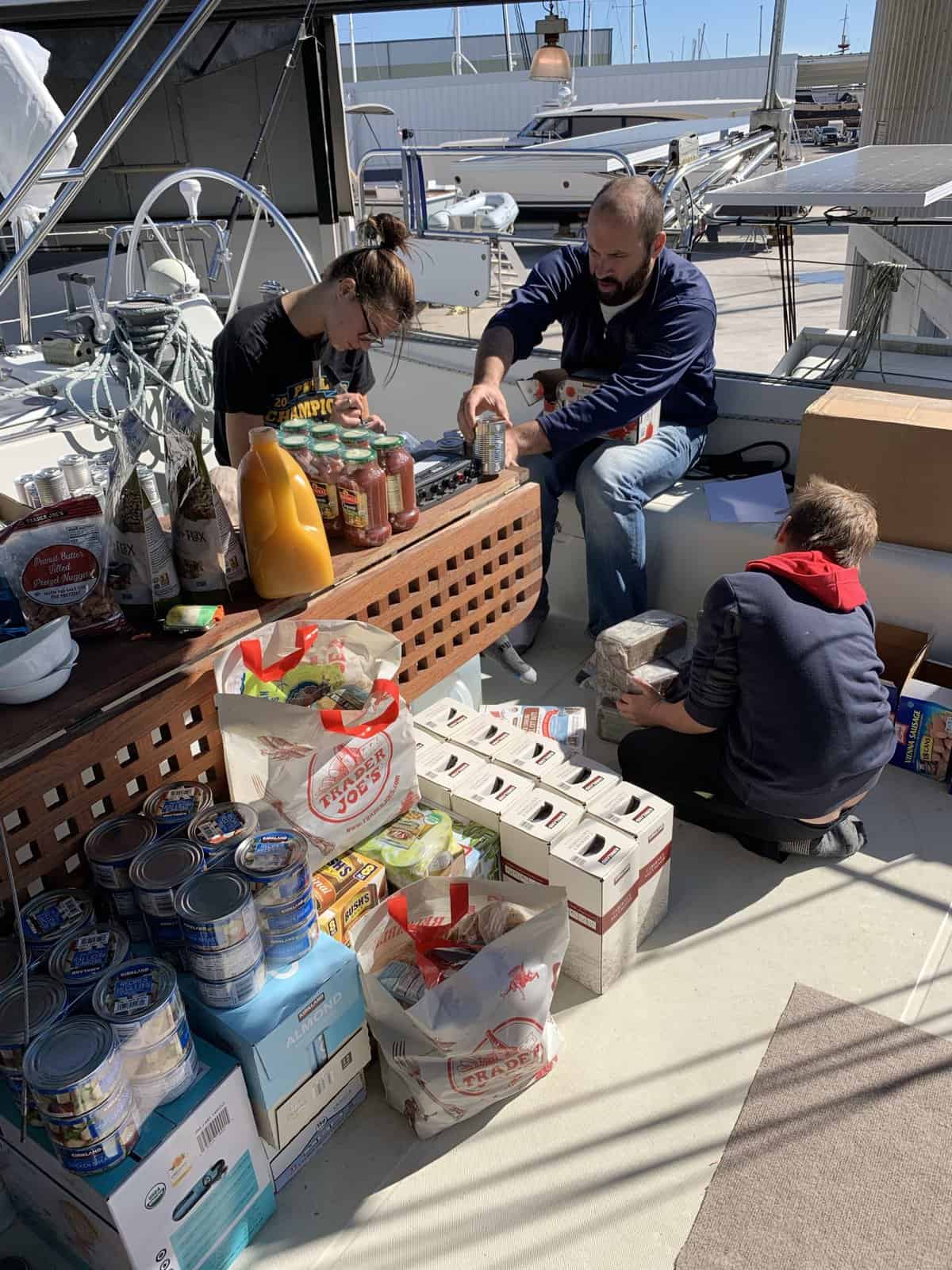 people labeling provisions on a sailboat
