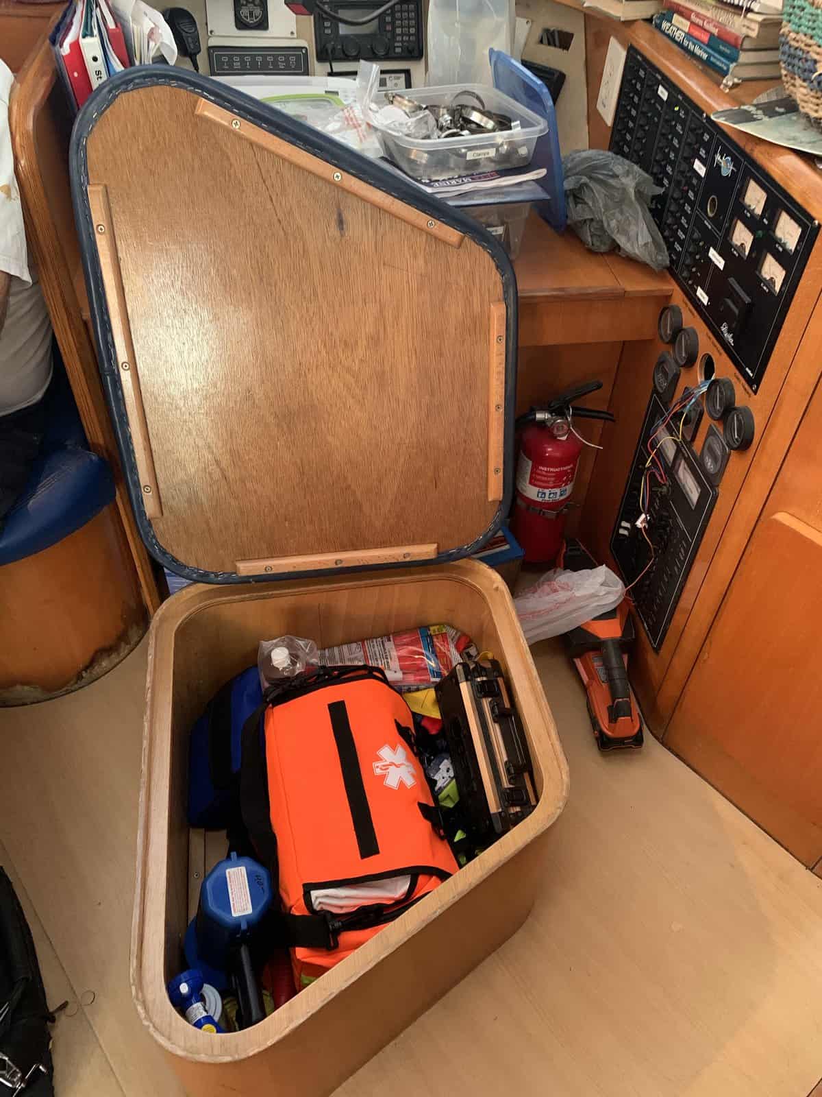 a bright orange first responder bag inside the navigation chair on a boat