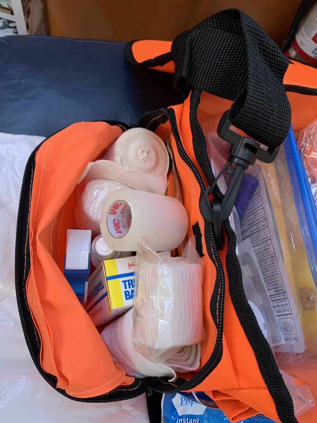 first responder orange bag pocket open to reveal trauma treat supplies