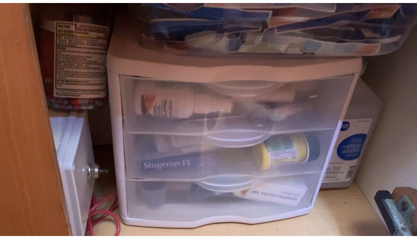 a plastic clear cabiner with three drawers and some medical supplies inside
