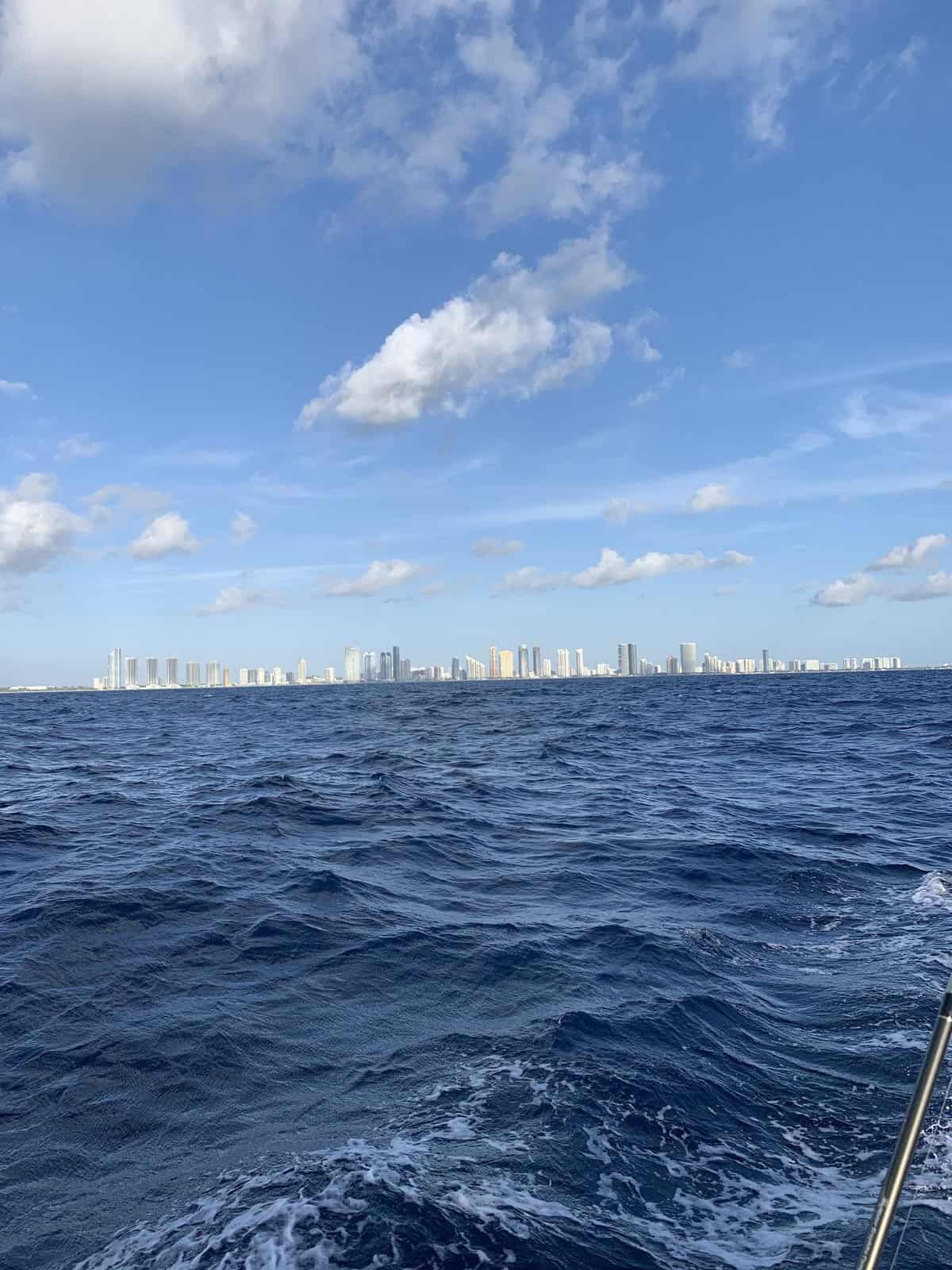 a view of busy downtown from a sailboat