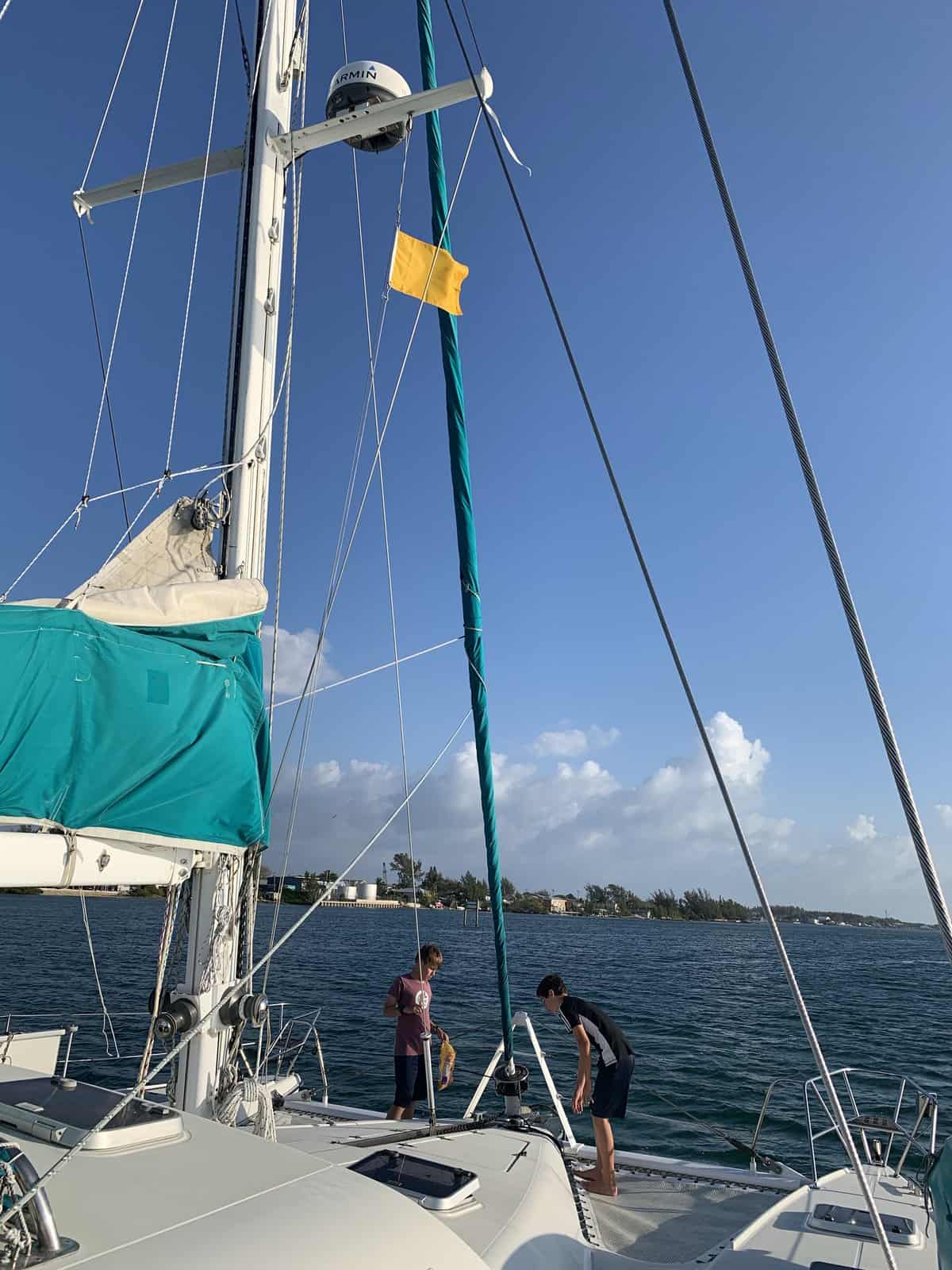 sailboat in Bimini with yellow quarantine flag