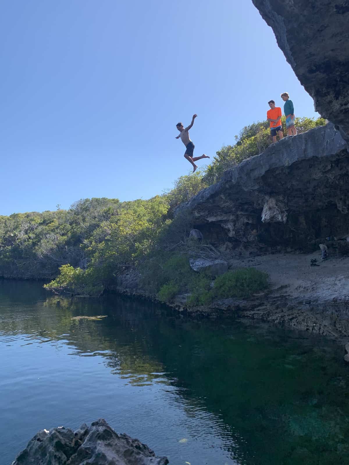 Joey jumping into the Hoffman's Cay Blue Hole