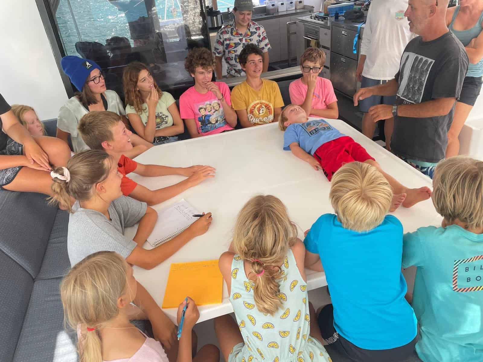 a worldschooling co-op with around 20 children gathered for a first-aid class. 