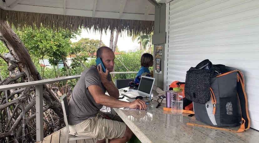 Joe, on his phone with the IRS, at a marina in Puerto Rico. 