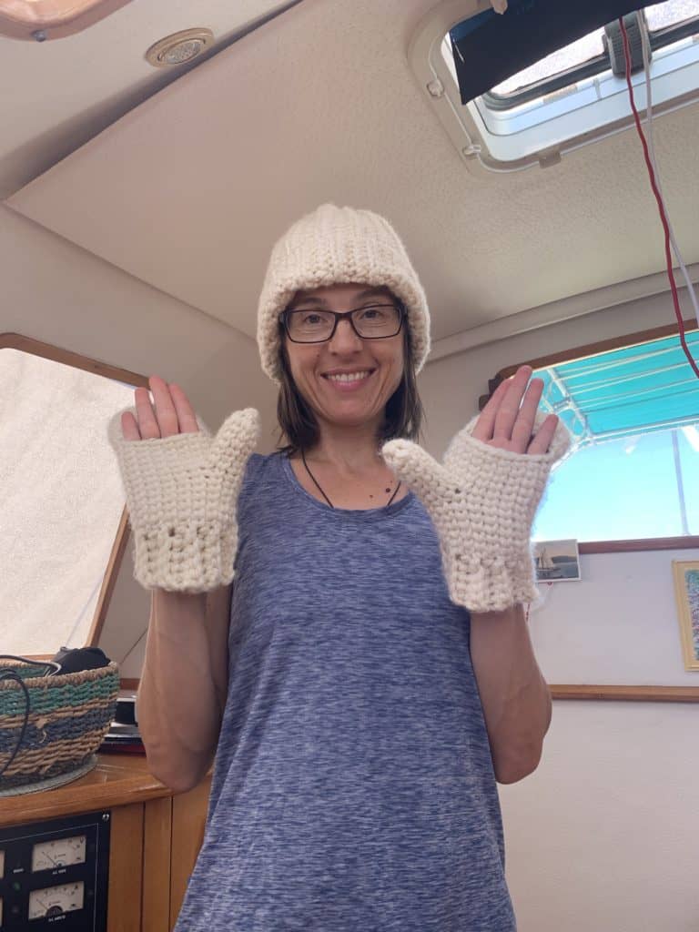 crochet hat and mittens on a sailboat