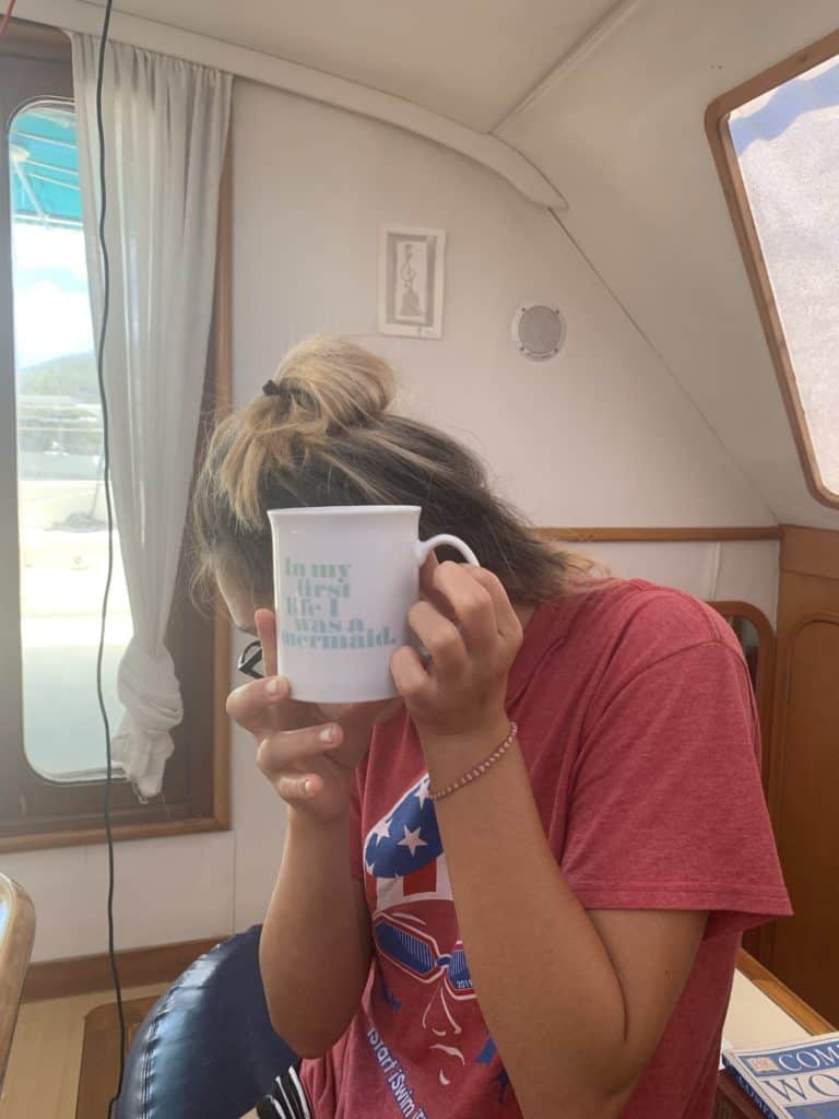 a girl holding a mug - mugs with slogans are great gifts for boaters