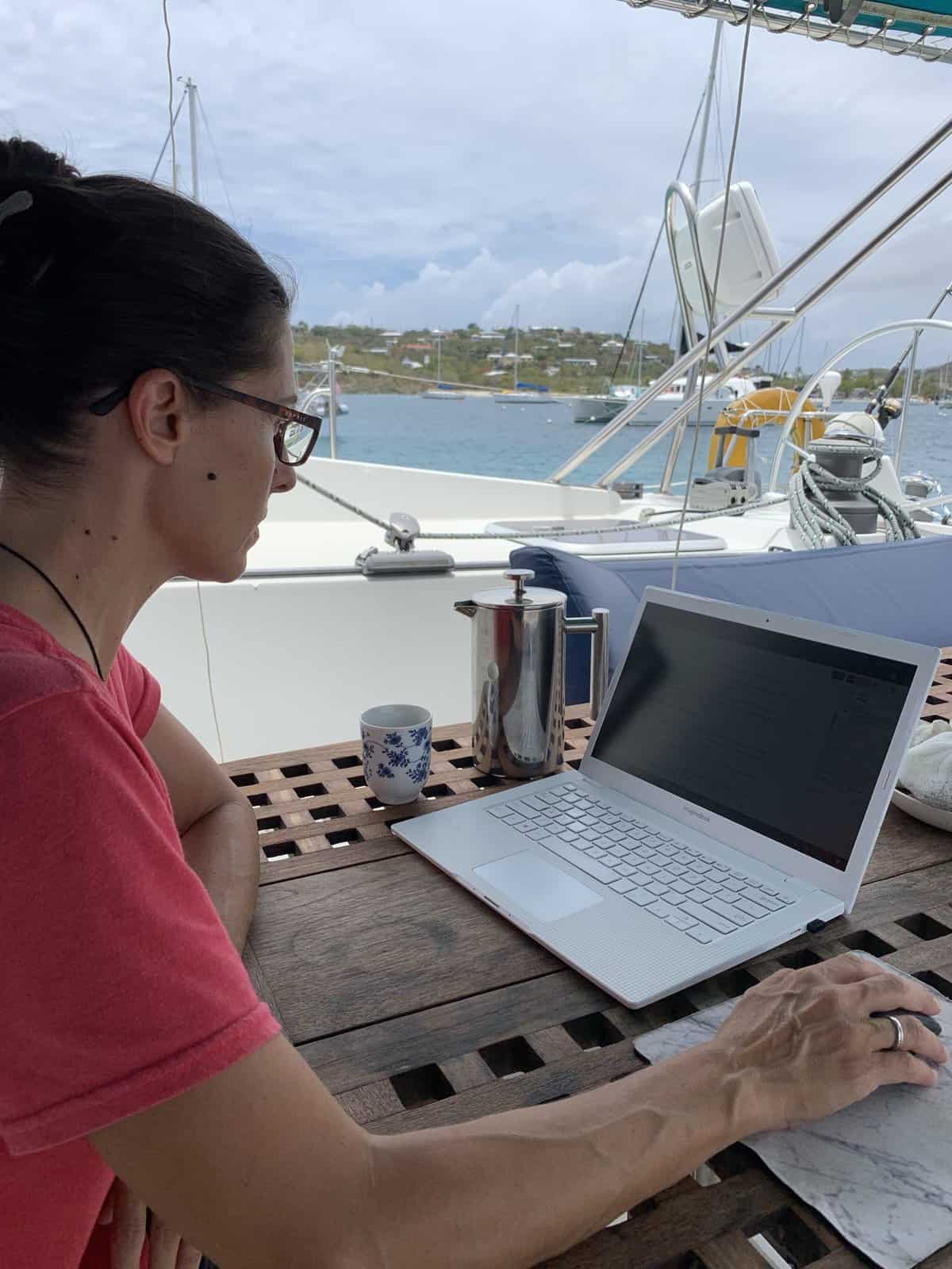 Mina on her laptop at the boat. In the process of writing the fun and useful traveling blog
