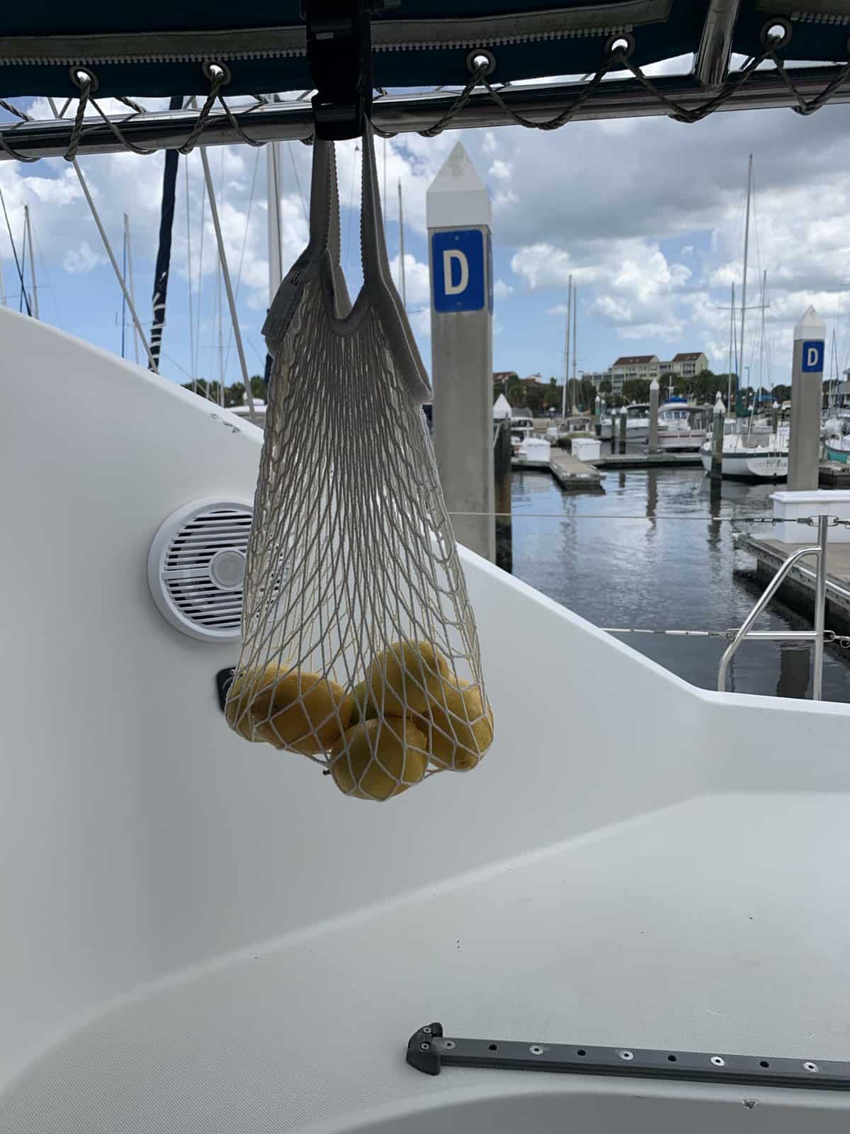lemons hanging in a mesh bag on a sailboat