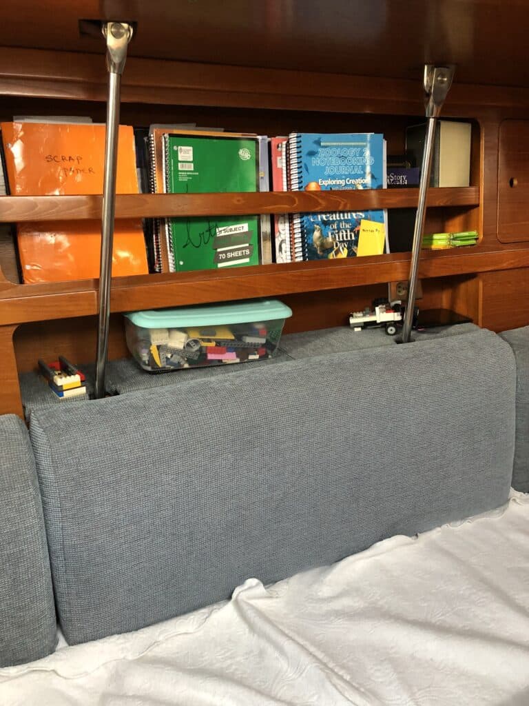 We fit our world-schooling supplies on various shelves on the small boat
