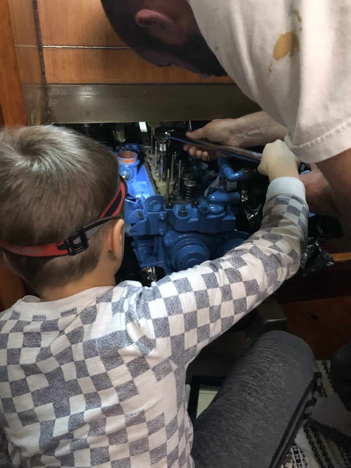 Bobby helping daddy with the engine
