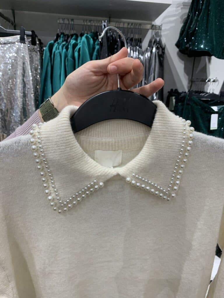 a white shirt on a hanger, in a shop