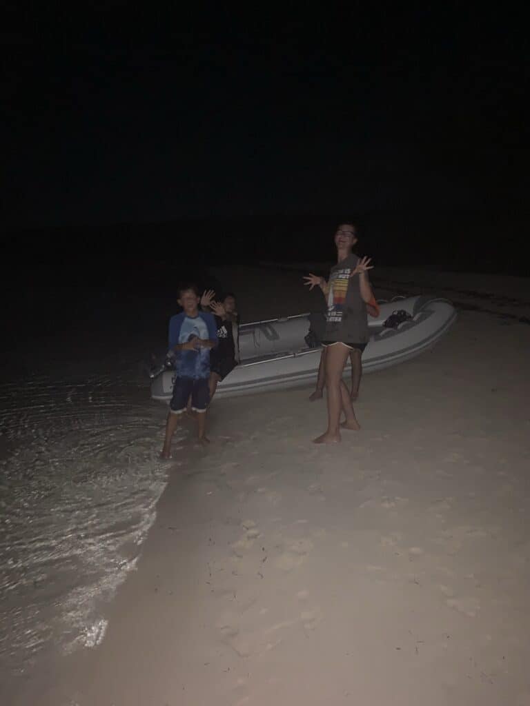 kids playing on the beach at dark
