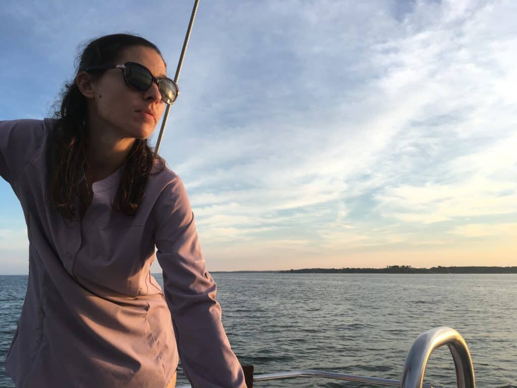 a woman on a boat wearing a pink Columbia sun shirt