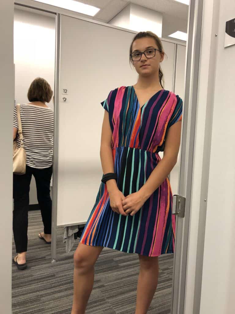 a girl in a striped tunic dress
