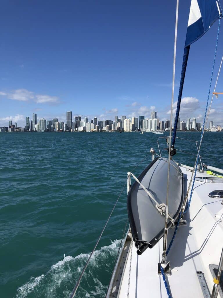A boat sailing with Miami in the background.