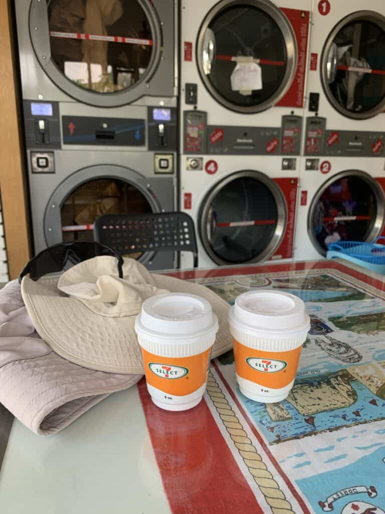 two coffees with laundromat in the background