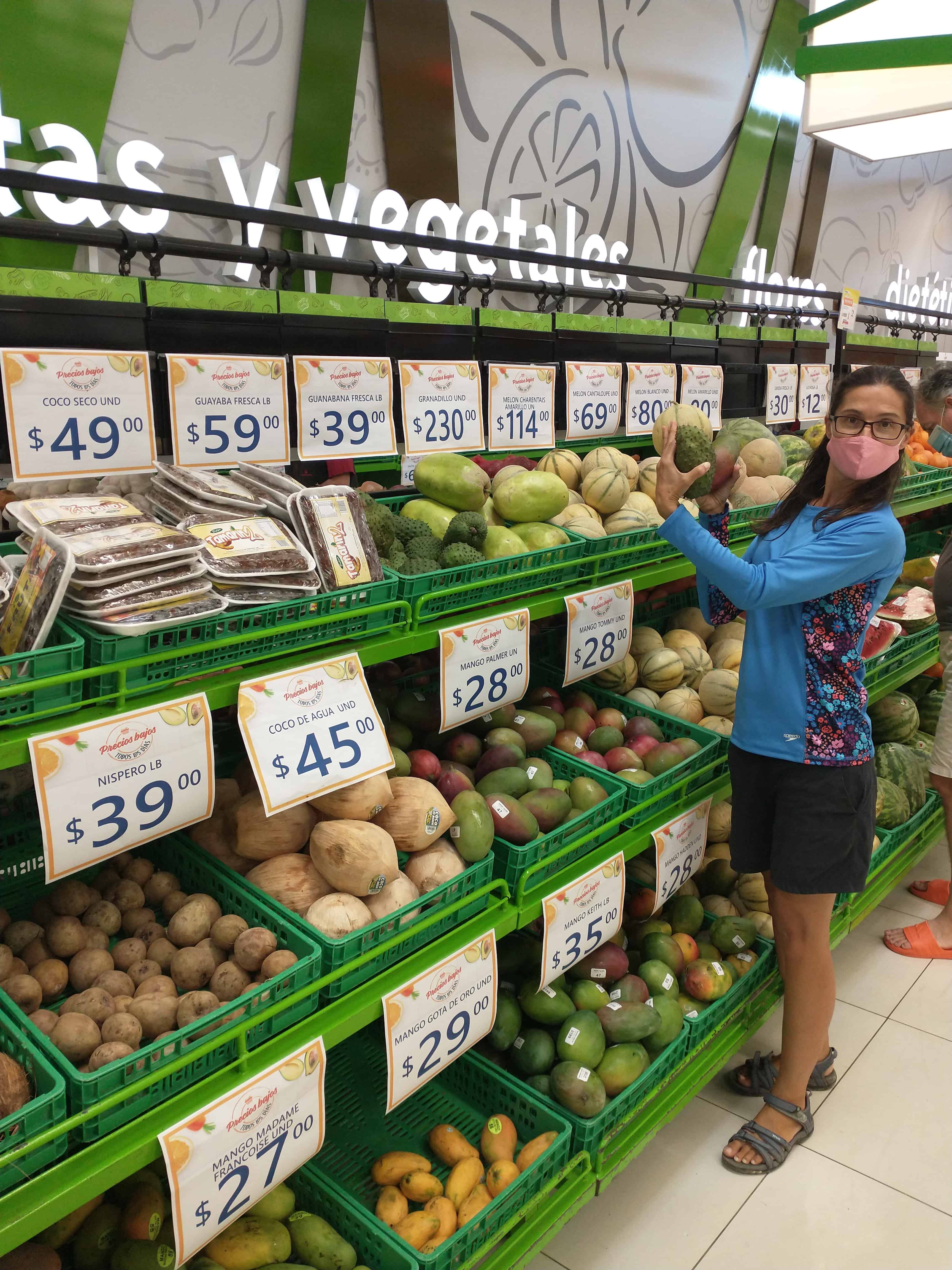 a produce section at a grocery store in the dominican republic, showing prices