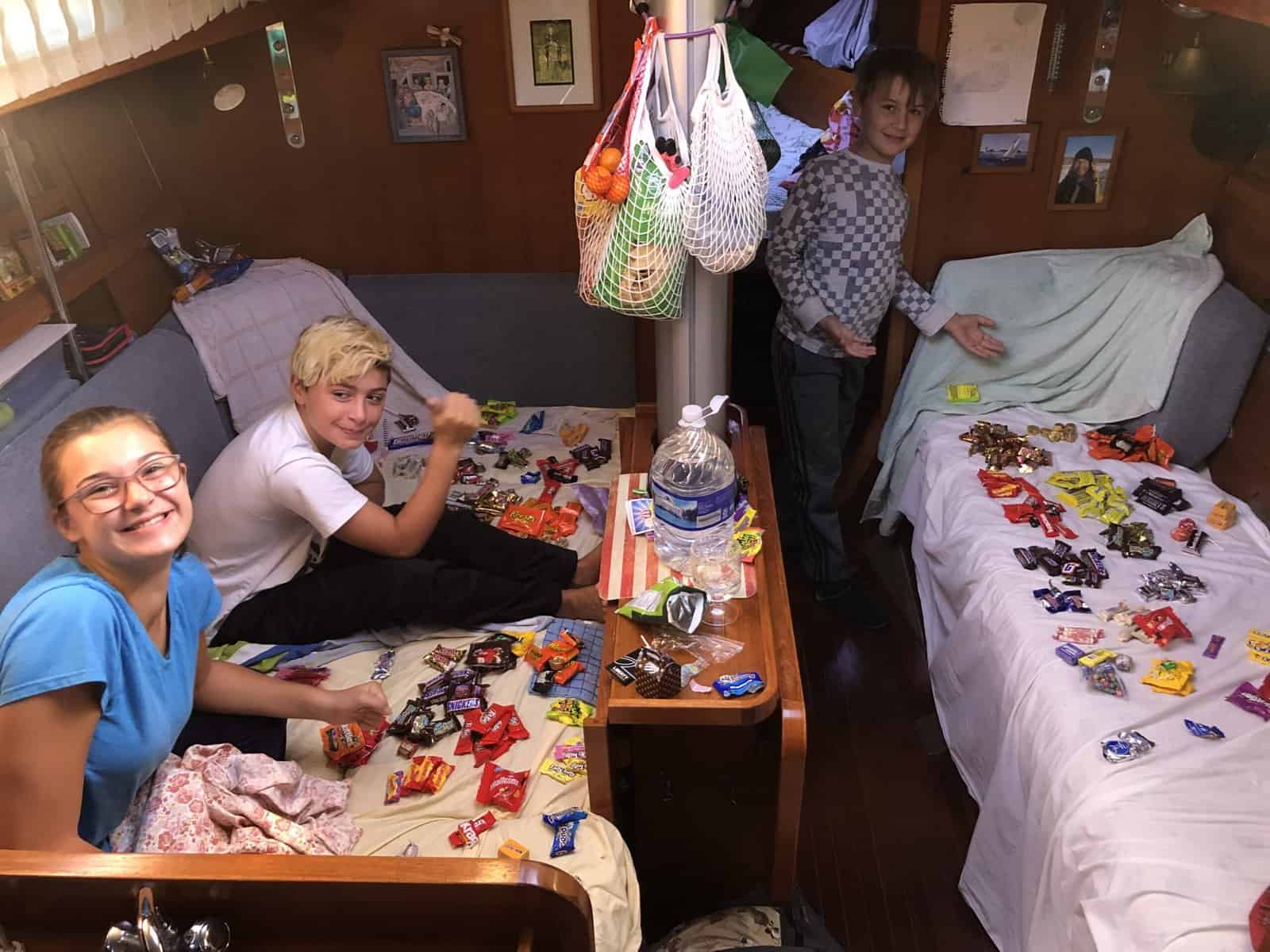kids with lots of Halloween candy aboard a boat