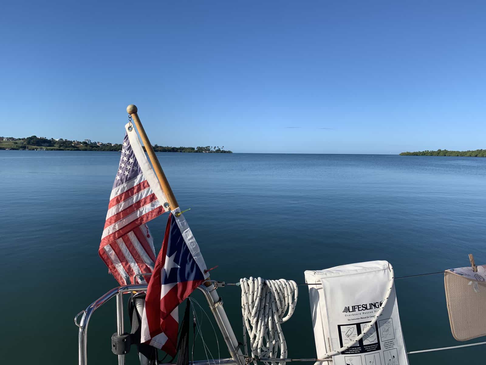 lifesling next to flags aboard a sailboat